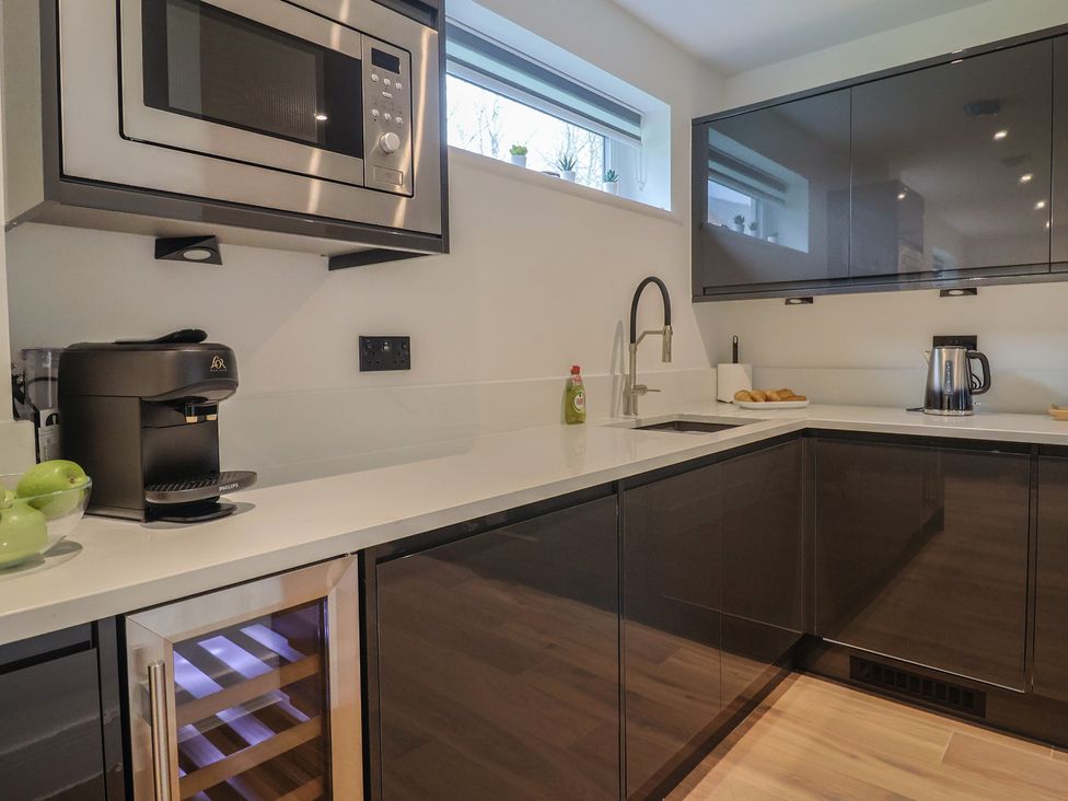 A kitchen with a sink and coffee maker at Pine Lodge in Westonzoyland nr. Bridgwater
