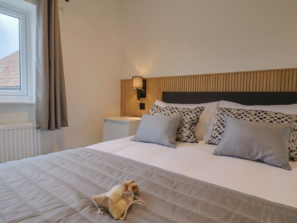 A bedroom with a bed and pillows at Pine Lodge in Westonzoyland nr. Bridgwater