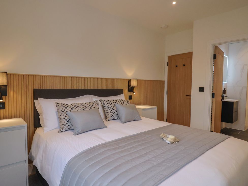 A bedroom with a bed and bedside tables at Pine Lodge Westonzoyland nr. Bridgwater