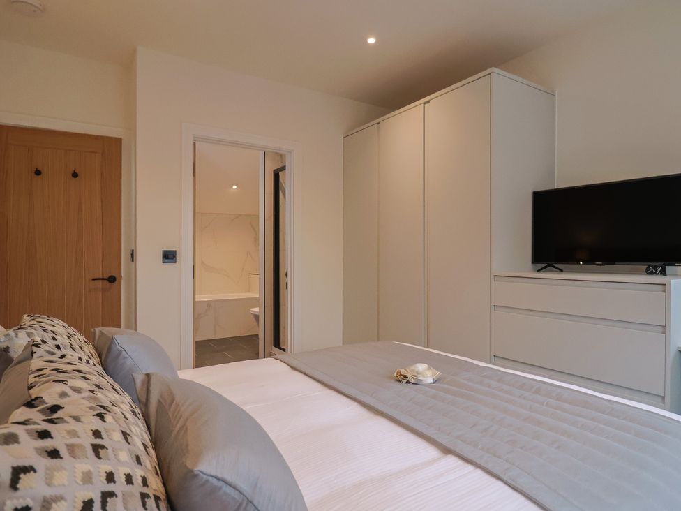 A bedroom with a bed and wardrobe at Pine Lodge in Westonzoyland nr. Bridgwater