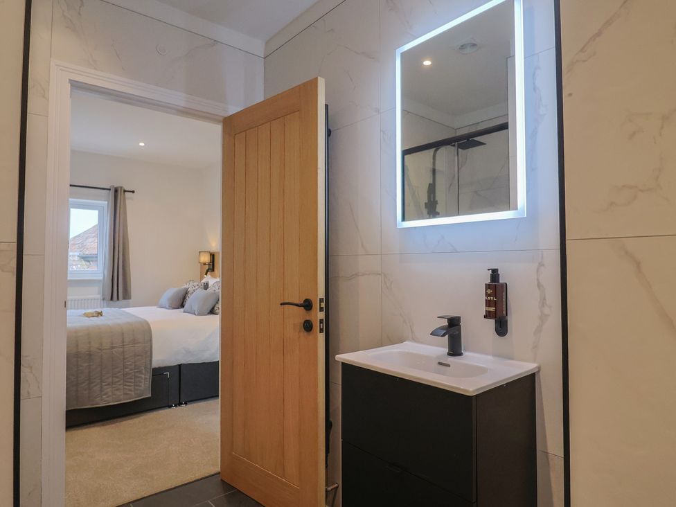 A bathroom with a sink and mirror at Pine Lodge in Westonzoyland nr. Bridgwater