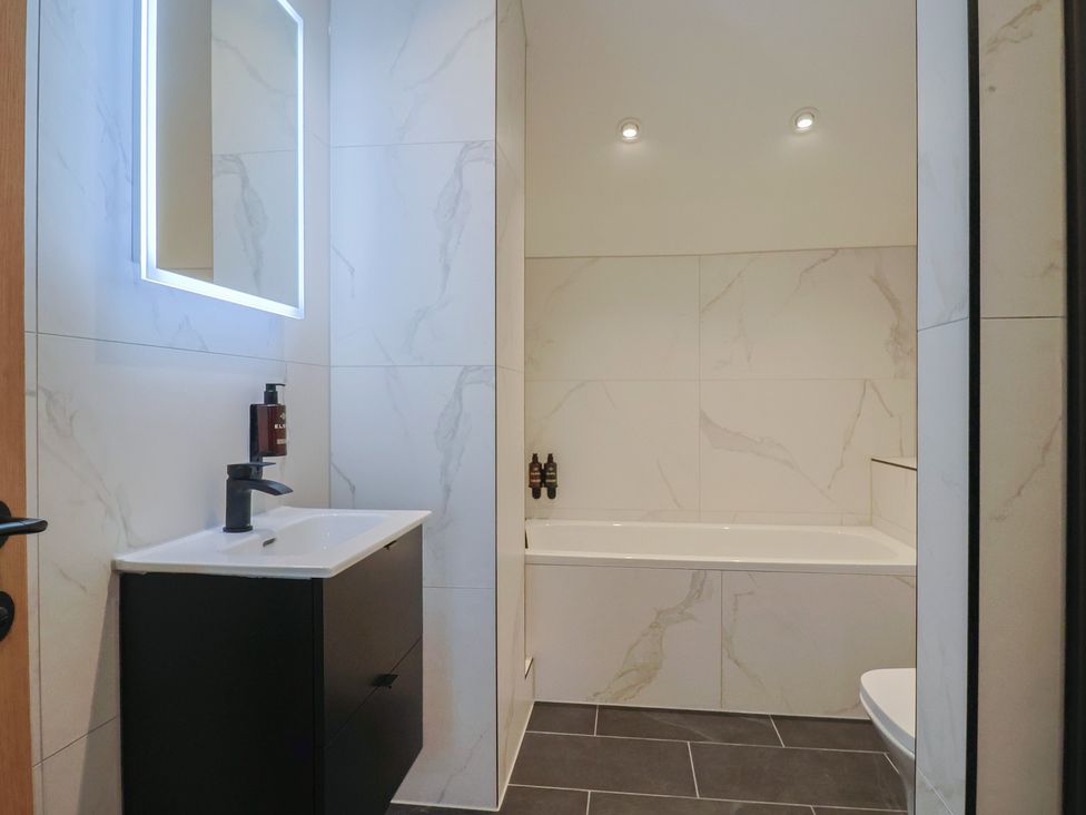 A bathroom with a sink, bathtub, and toilet at Pine Lodge Westonzoyland nr. Bridgwater
