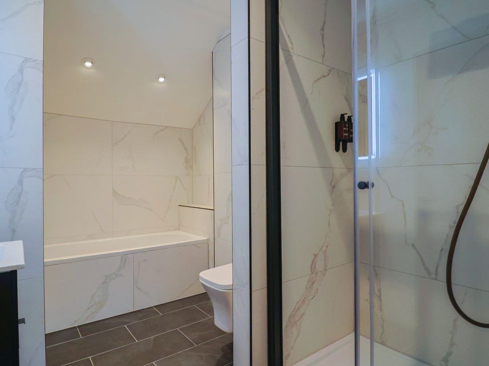 A bathroom with a bathtub and shower at Pine Lodge in Westonzoyland nr. Bridgwater