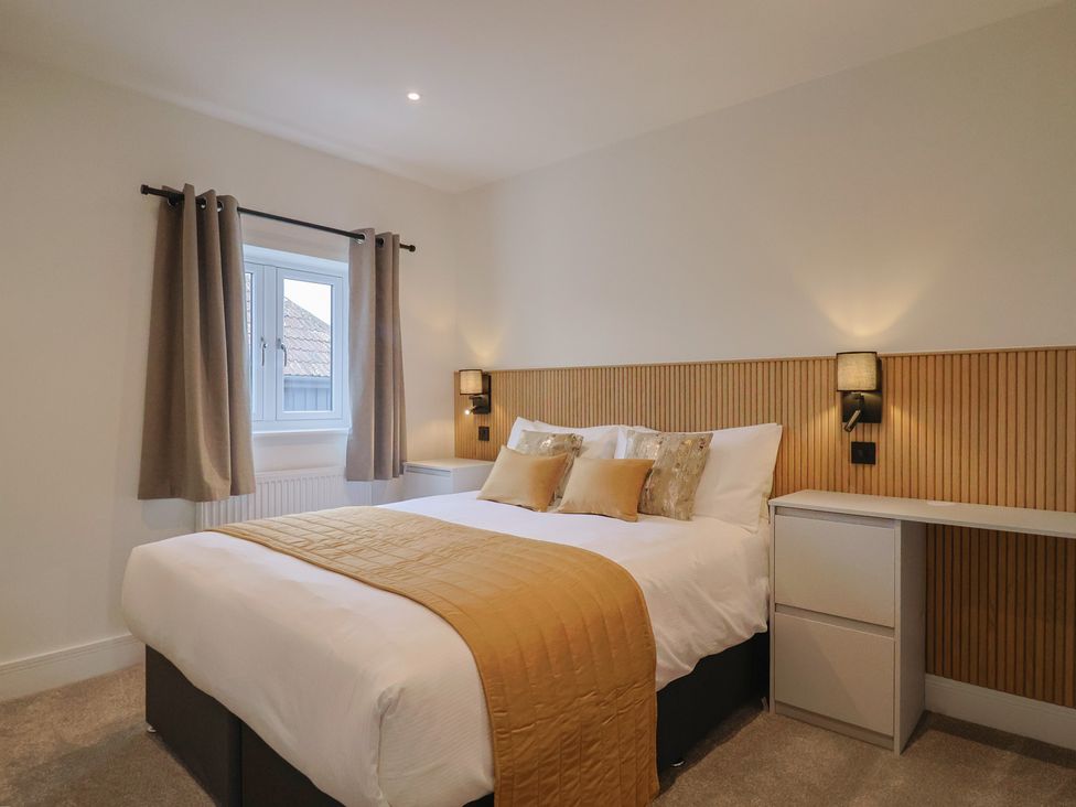 A bedroom with a bed and nightstand at Pine Lodge in Westonzoyland nr. Bridgwater