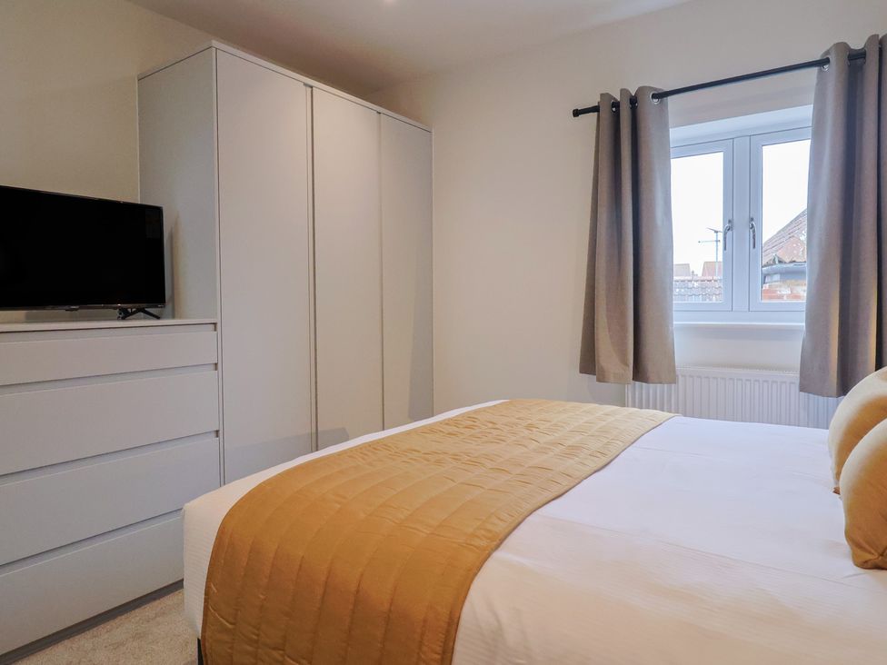 A bedroom with a bed and television at Pine Lodge Westonzoyland nr. Bridgwater