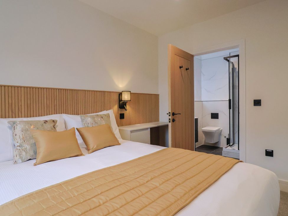 A bedroom with a bed and adjoining bathroom at Pine Lodge in Westonzoyland nr. Bridgwater