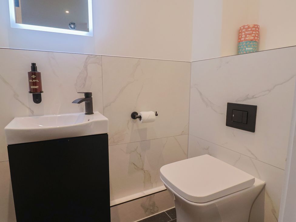 A bathroom with a sink and toilet at Pine Lodge in Westonzoyland nr. Bridgwater
