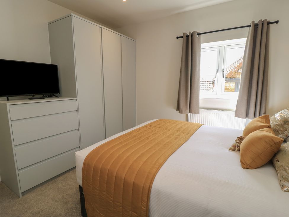 A bedroom with a bed and wardrobe at Pine Lodge in Westonzoyland nr. Bridgwater