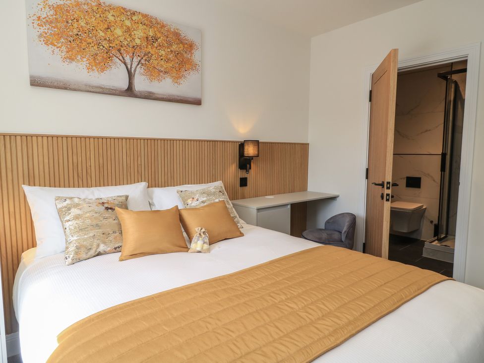 A bedroom with a bed and desk at Pine Lodge Westonzoyland nr. Bridgwater