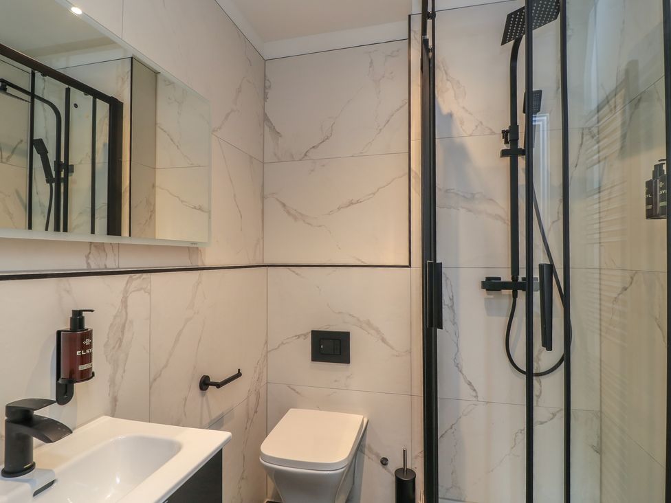 A bathroom with a shower, toilet, and sink at Pine Lodge Westonzoyland nr. Bridgwater