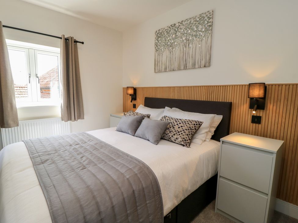 A bedroom with a bed and artwork on the wall at Pine Lodge Westonzoyland nr. Bridgwater