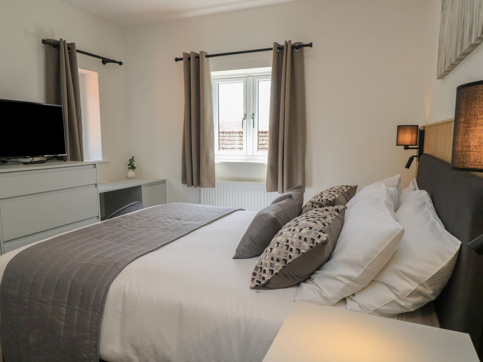 A bedroom with a bed and television at Pine Lodge Westonzoyland nr. Bridgwater