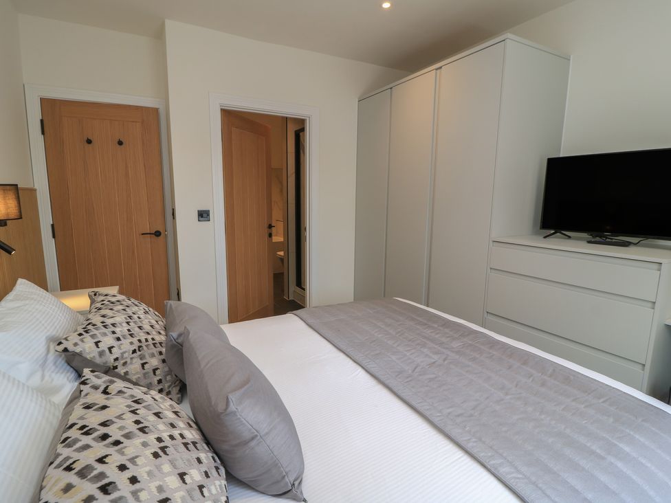 A bedroom with a bed and wardrobe at Pine Lodge in Westonzoyland nr. Bridgwater