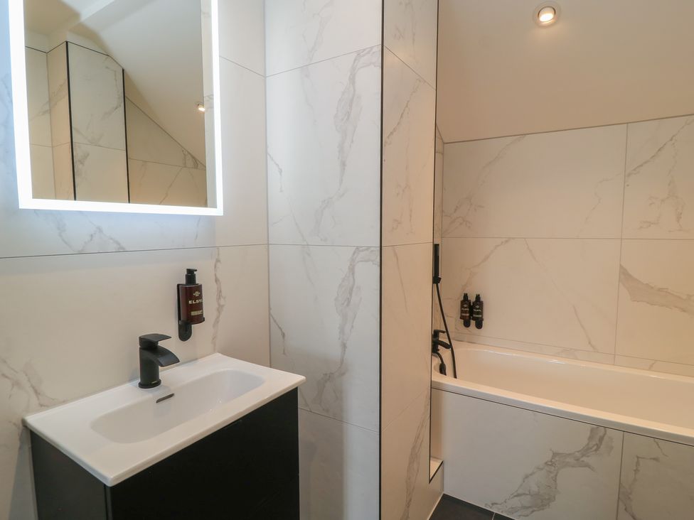 A bathroom with a sink and bathtub at Pine Lodge Westonzoyland nr. Bridgwater