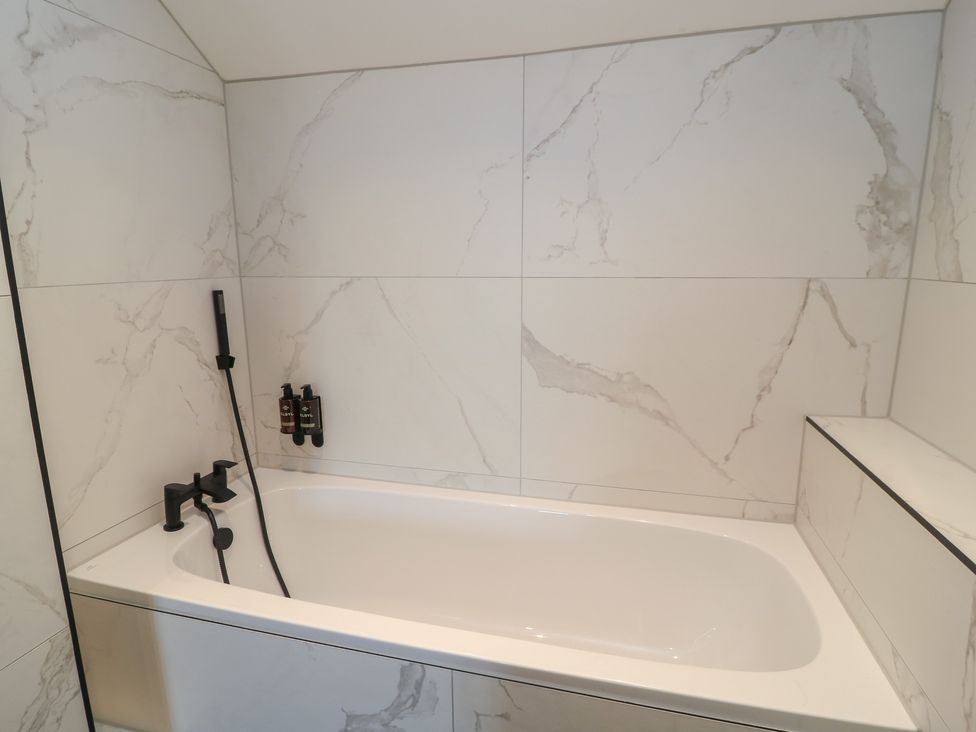 A bathroom featuring a bathtub and shower controls at Pine Lodge Westonzoyland nr. Bridgwater