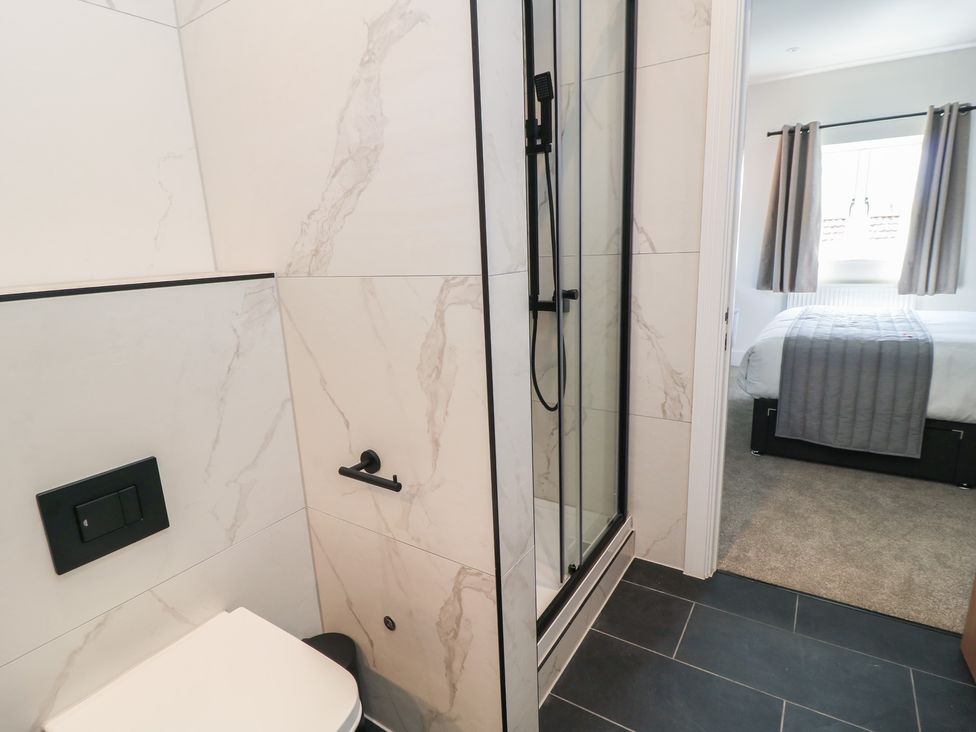 A bathroom with a shower and toilet at Pine Lodge Westonzoyland nr. Bridgwater