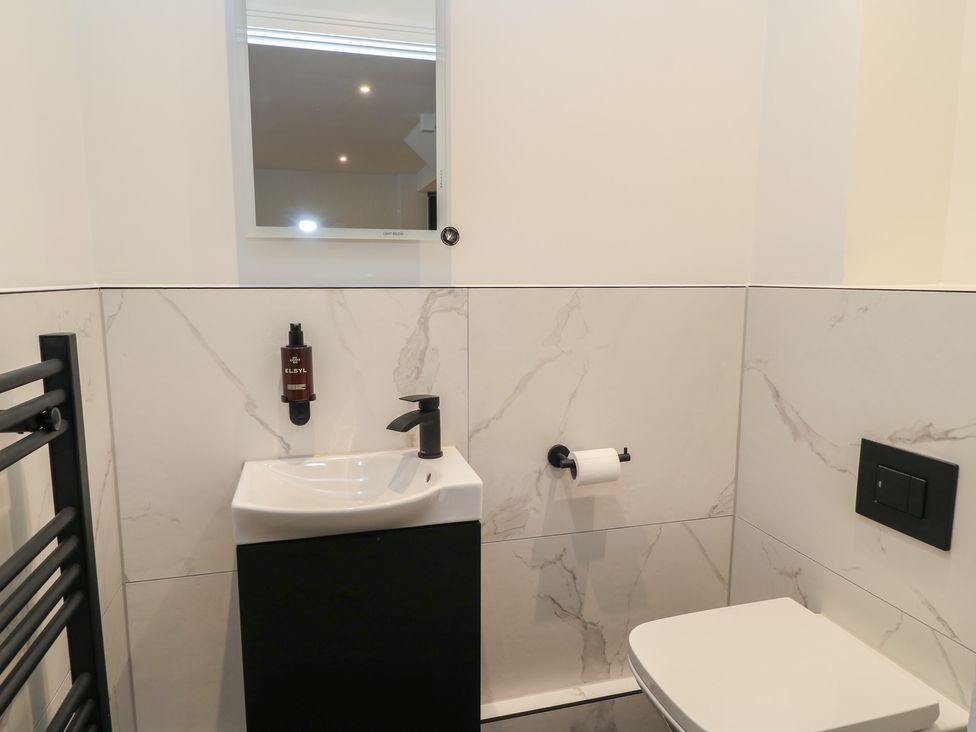 A bathroom with sink and toilet at Pine Lodge in Westonzoyland nr. Bridgwater