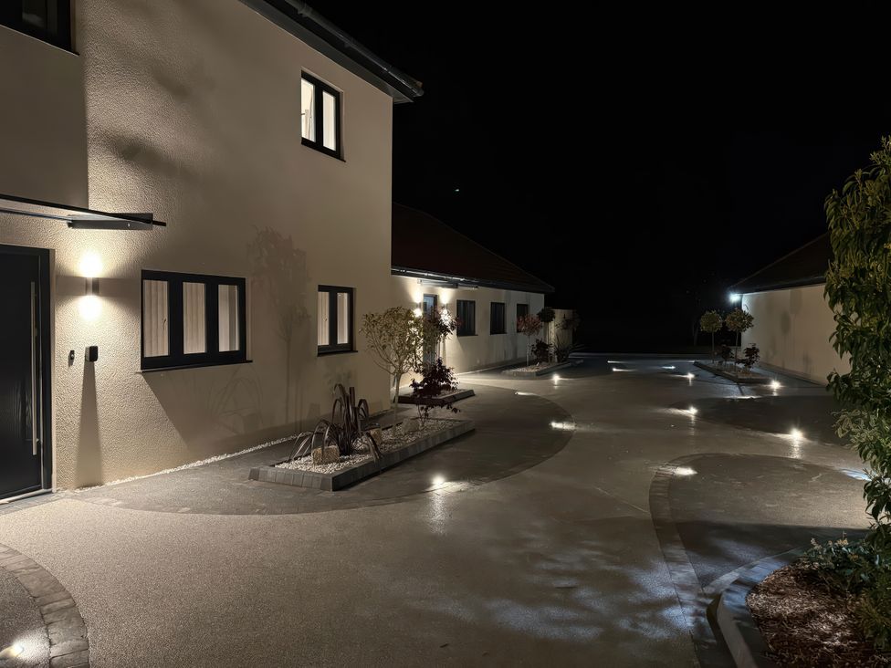 An outdoor area with house, driveway and plants at Pine Lodge Bridgwater
