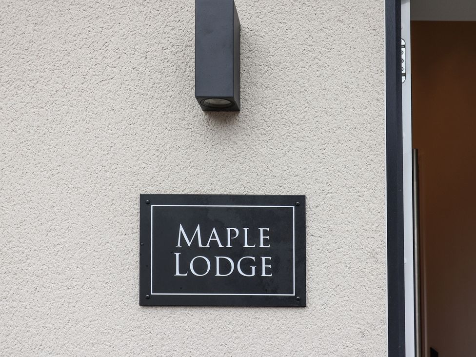A sign that reads Maple Lodge on an exterior wall at Maple Lodge Westonzoyland nr. Bridgwater