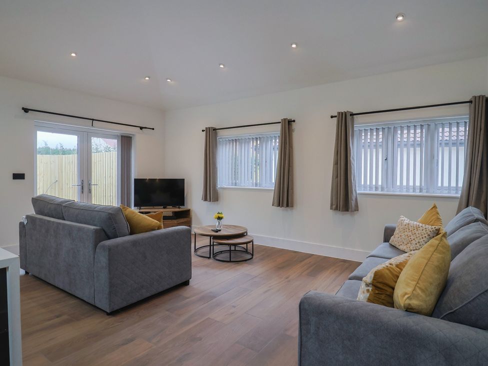 A living room with a sofa and television at Maple Lodge in Westonzoyland nr. Bridgwater