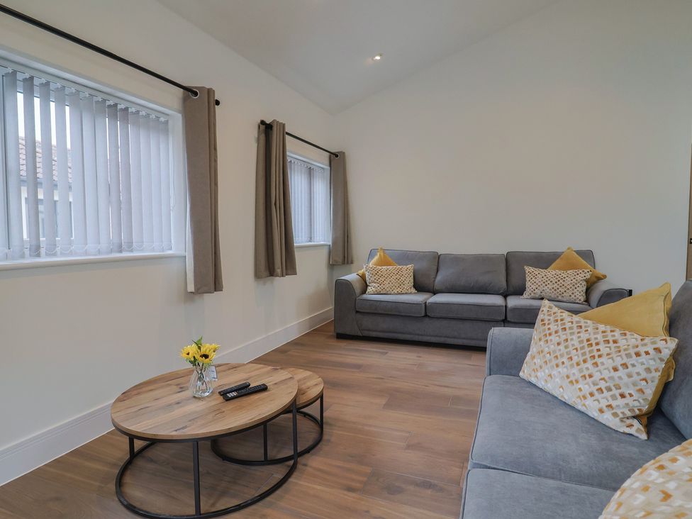 A living room with a sofa and coffee table at Maple Lodge Westonzoyland nr. Bridgwater