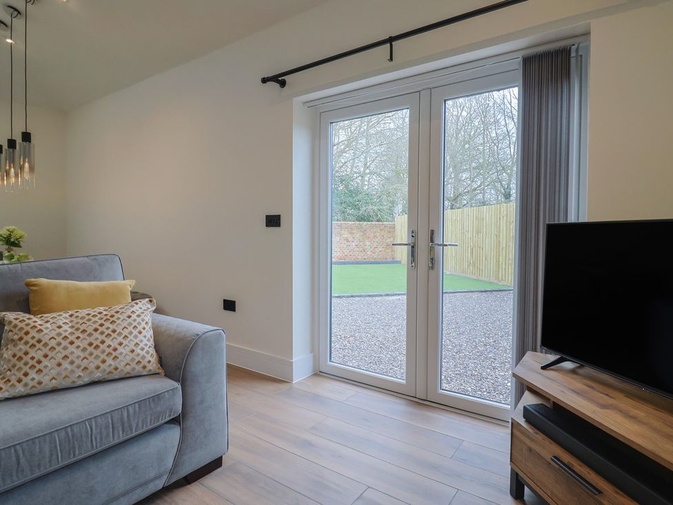 A living room with a sofa and television at Maple Lodge Westonzoyland nr. Bridgwater