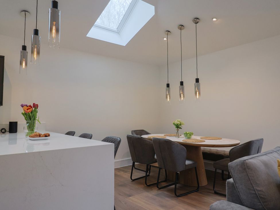 A dining room with a table and chairs at Maple Lodge Westonzoyland nr. Bridgwater