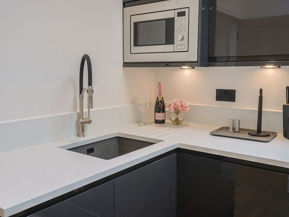 A kitchen with a sink and microwave at Maple Lodge Westonzoyland nr. Bridgwater