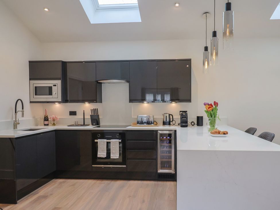A kitchen with modern appliances and seating at Maple Lodge Westonzoyland nr. Bridgwater