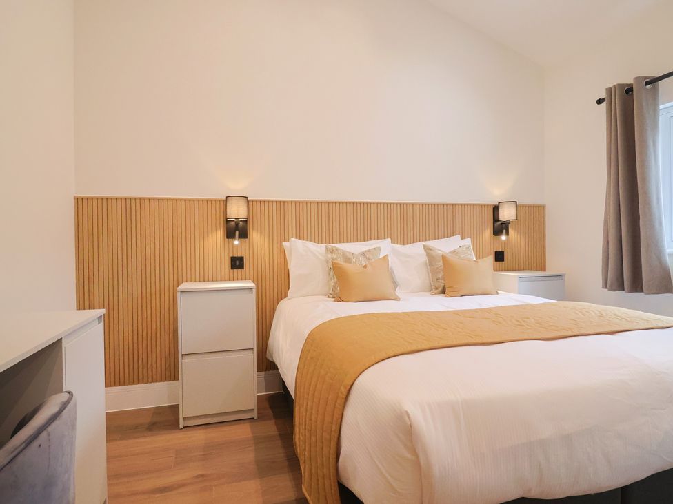 A bedroom with a bed and bedside tables at Maple Lodge in Westonzoyland nr. Bridgwater