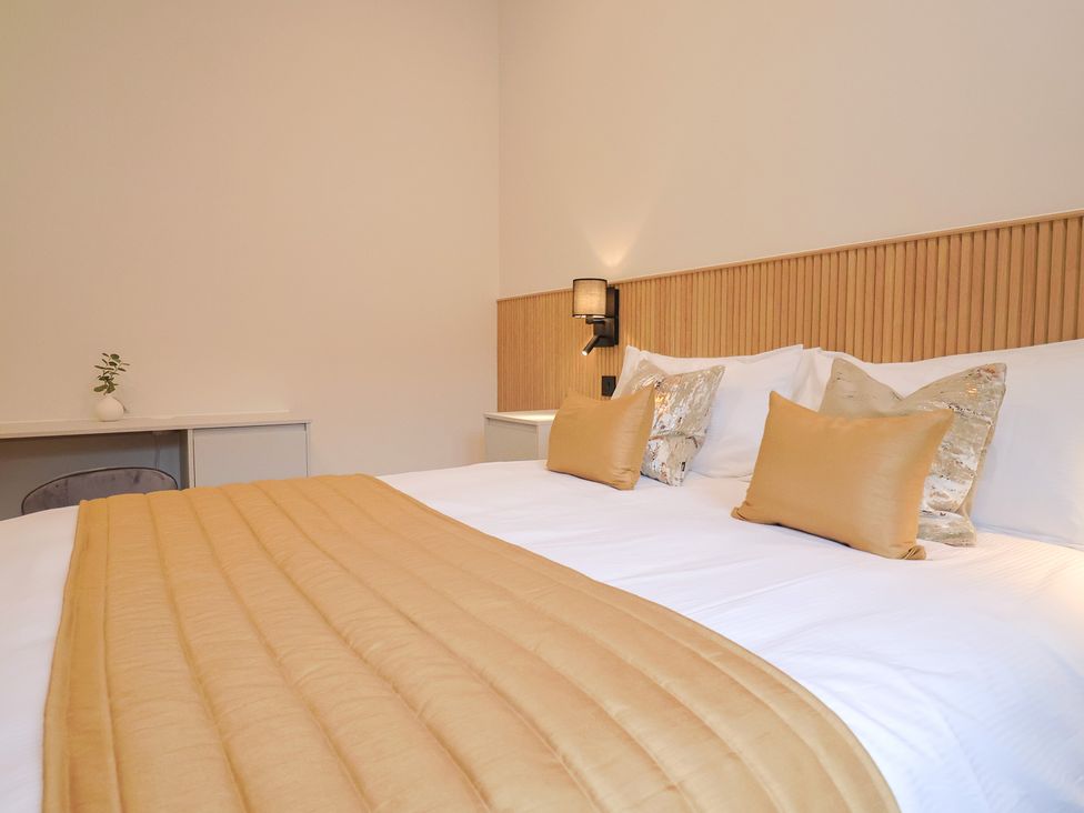 A bedroom with a bed and desk at Maple Lodge, Westonzoyland nr. Bridgwater