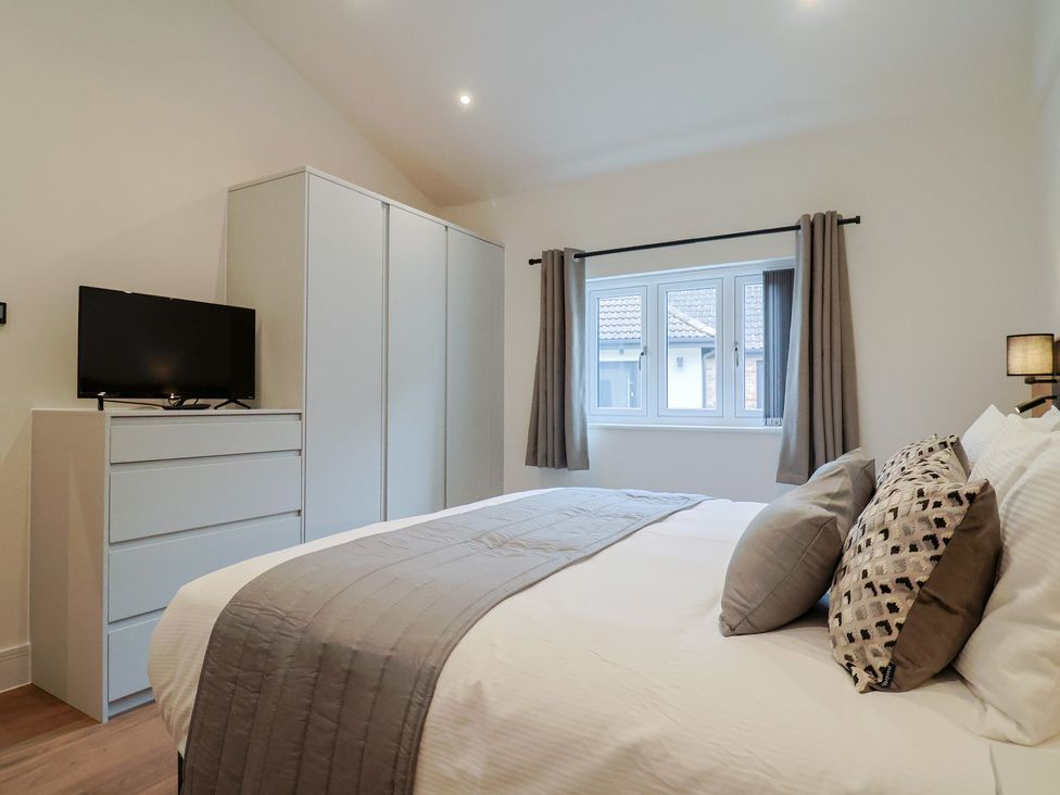 A bedroom with a bed and a television at Maple Lodge Westonzoyland nr. Bridgwater