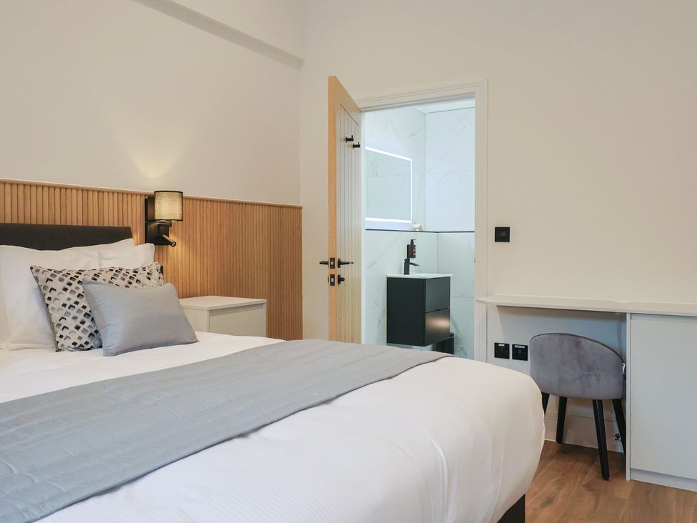 A bedroom with a bed and a bathroom view at Maple Lodge in Westonzoyland nr. Bridgwater