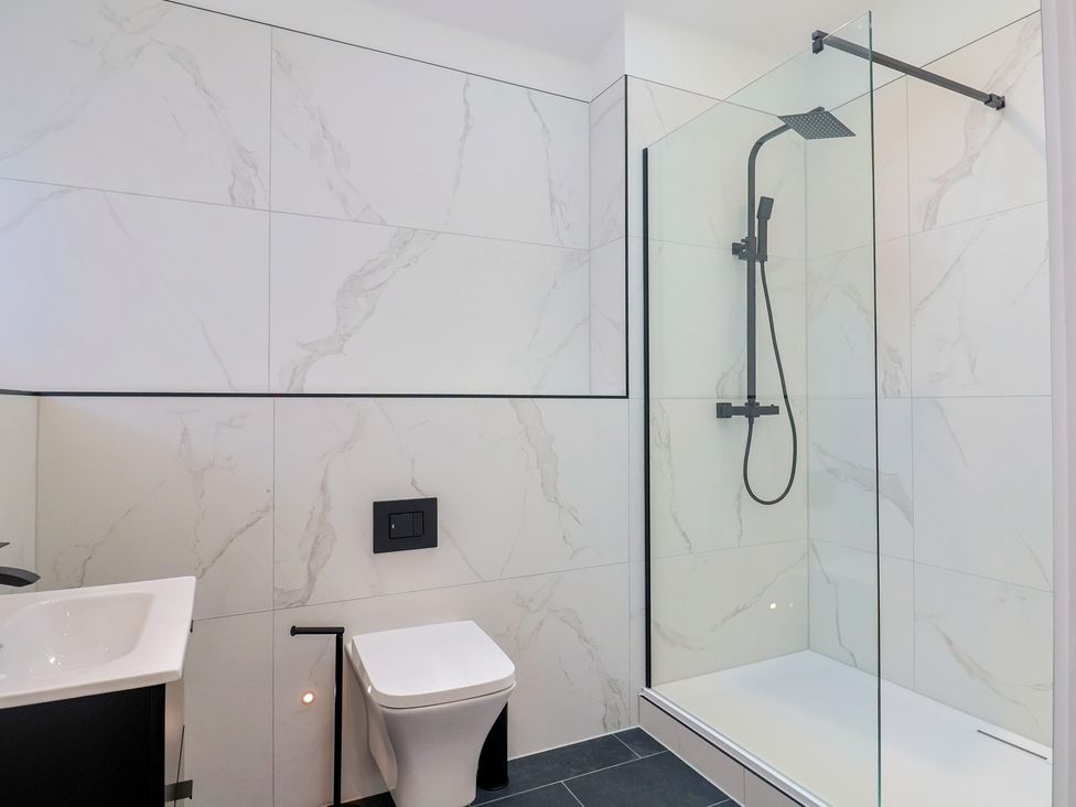A bathroom featuring a shower, toilet, and vanity at Maple Lodge Westonzoyland nr. Bridgwater