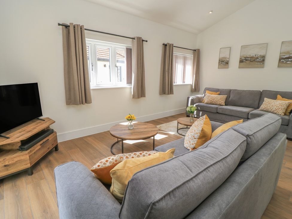 A living room with a sofa and coffee table at Maple Lodge in Westonzoyland near Bridgwater