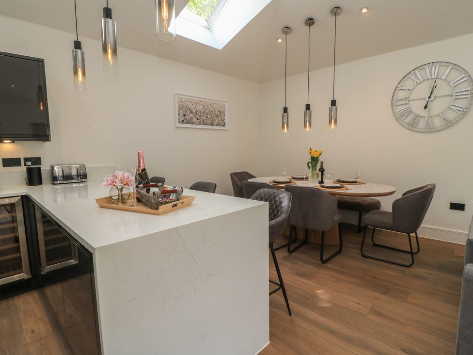 A dining room with table and chairs at Maple Lodge in Westonzoyland near Bridgwater