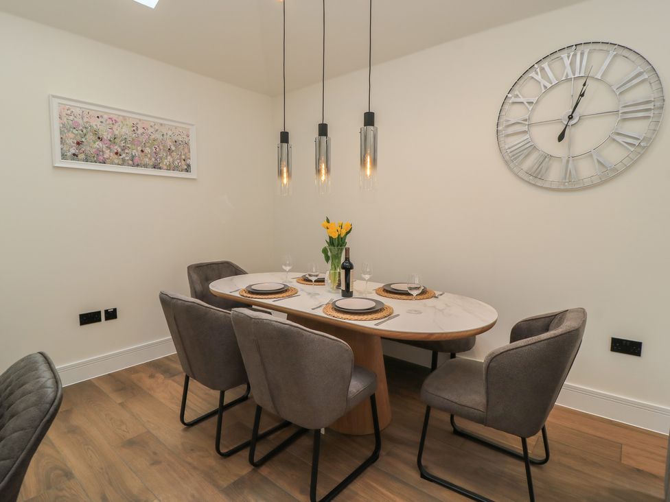 A dining room with a table and chairs at Maple Lodge in Westonzoyland near Bridgwater