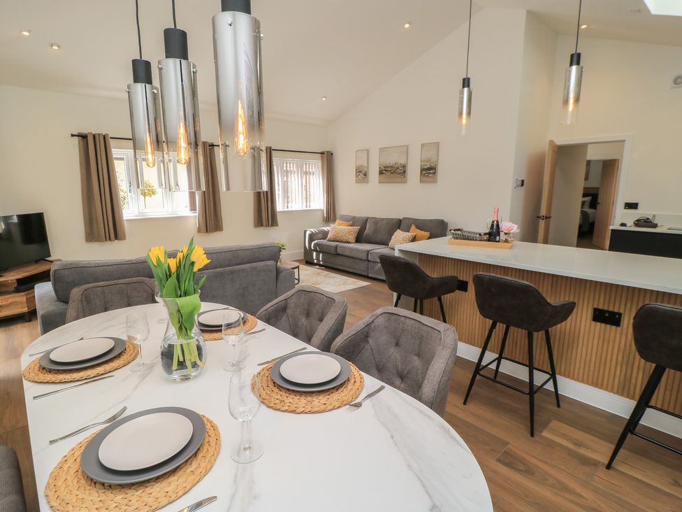 A dining area with a table and chairs at Maple Lodge Westonzoyland near Bridgwater