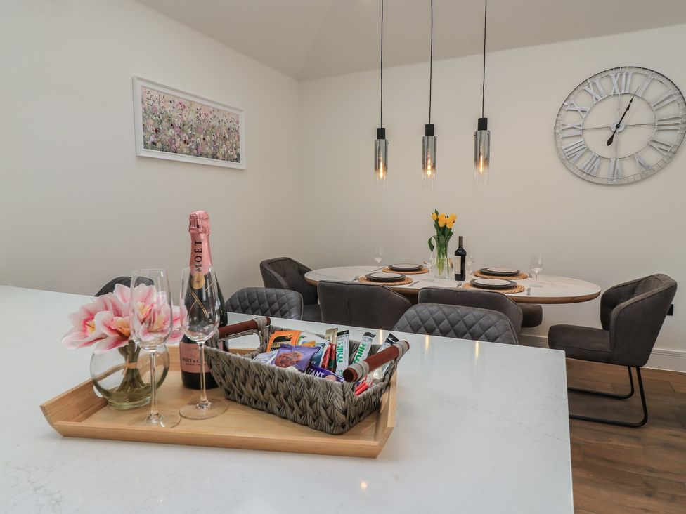 A dining room with a table set for a meal at Maple Lodge in Westonzoyland near Bridgwater
