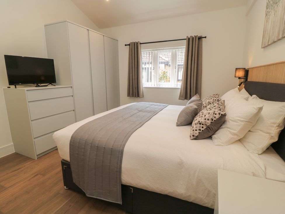 A bedroom with a bed and wardrobe at Maple Lodge in Westonzoyland near Bridgwater