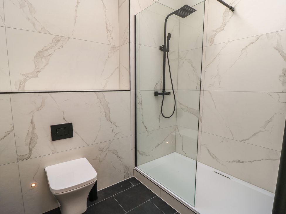 A bathroom featuring a shower and a toilet at Maple Lodge Westonzoyland near Bridgwater