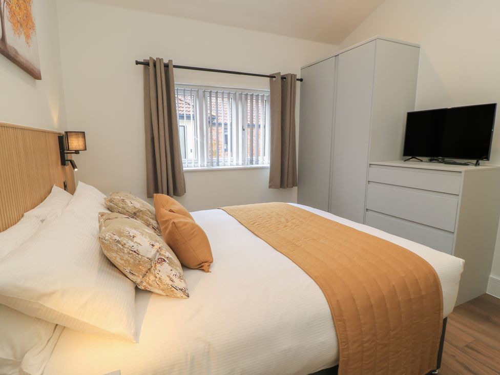 A bedroom with a bed and TV at Maple Lodge in Westonzoyland near Bridgwater