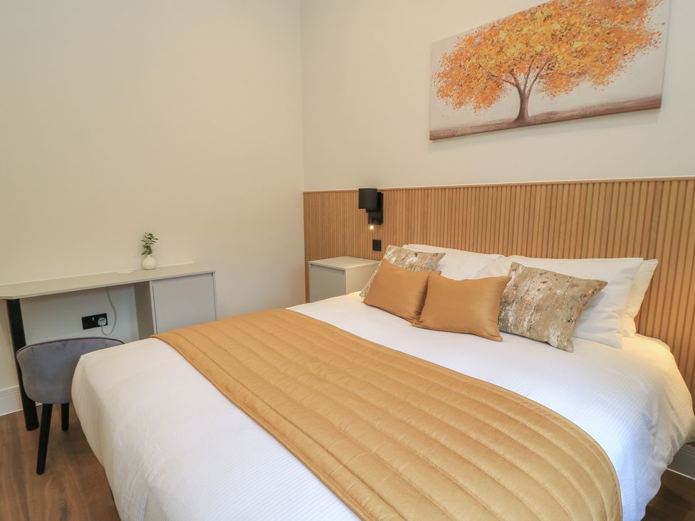 A bedroom with a bed and desk at Maple Lodge in Westonzoyland near Bridgwater