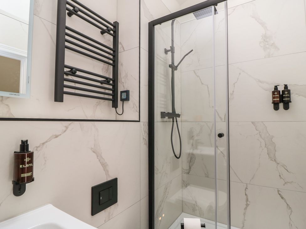 A bathroom with a shower and towel rail at Maple Lodge Westonzoyland near Bridgwater