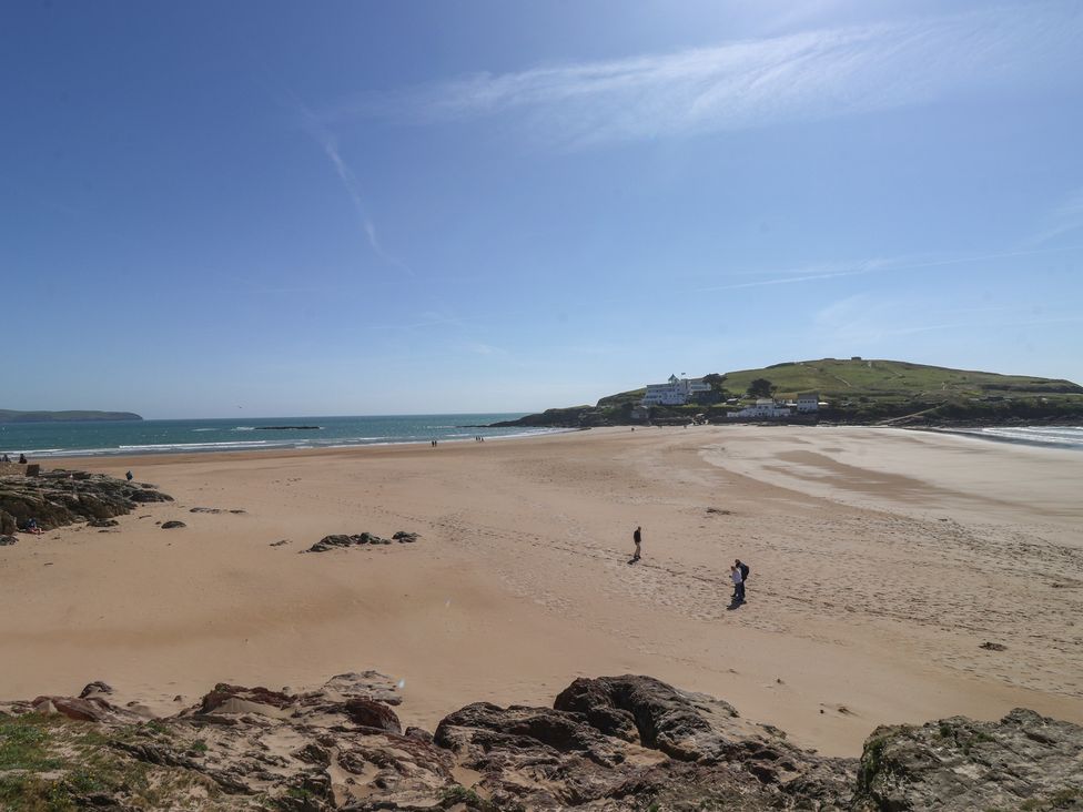 A beach with people walking and cliffs in the background at 6 Burgh Island Bigbury-On-Sea
