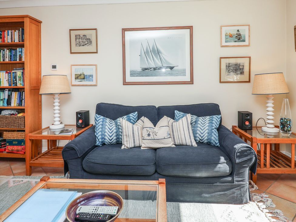 A living room with a couch and bookshelf at 6 Burgh Island in Bigbury-On-Sea