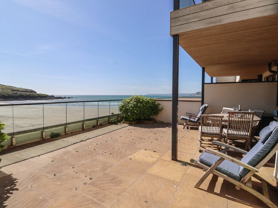 An outdoor terrace with seating and ocean view at 6 Burgh Island in Bigbury-On-Sea