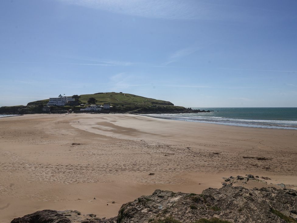 A beach with a view of a hill and buildings at 6 Burgh Island in Bigbury-On-Sea