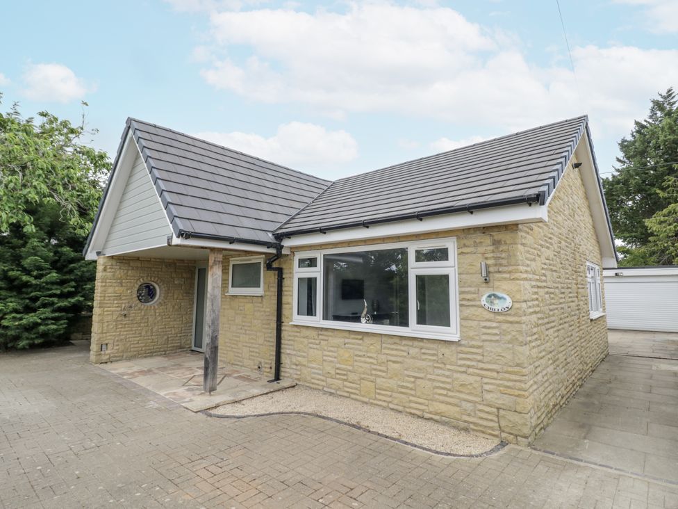A house with a pathway and garage at Chillon in South Littleton near Honeybourne