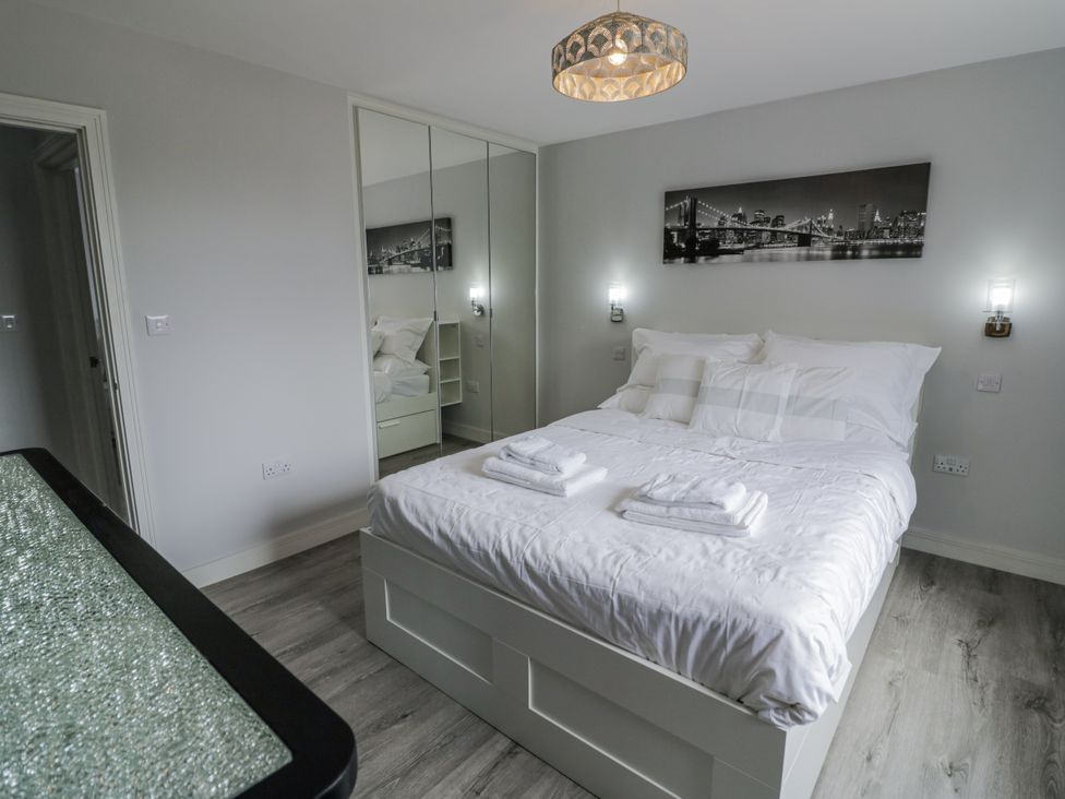 A bedroom featuring a bed with pillows at Chillon in South Littleton near Honeybourne